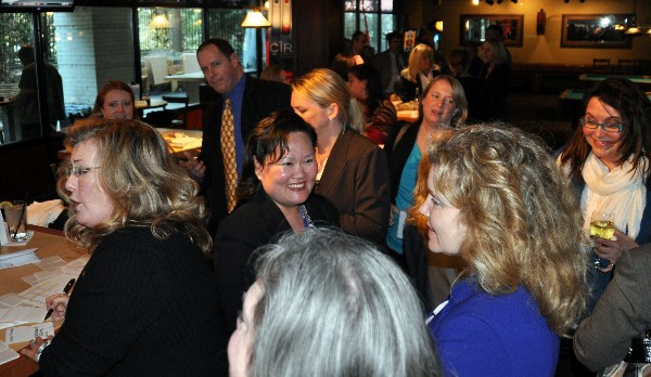 The crowd enjoys networking at the Women in Intelligence Group social in March.